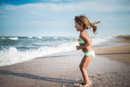 Joyful little girl enjoys a beach dayの写真素材