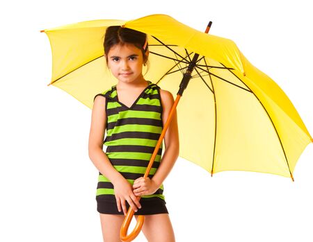 Little girl posing with yellow umbrellaの写真素材