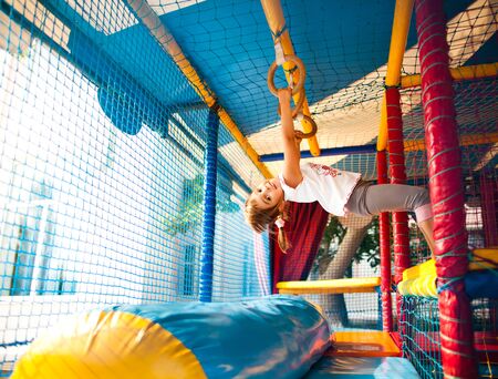 Girl hanging at colorful playground