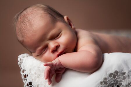 Adorable baby sleeping in suitcase.の写真素材