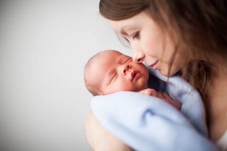 Loving mother holding newborn baby.の写真素材