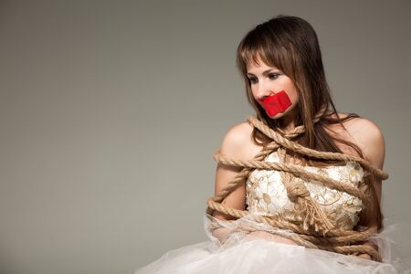 Woman tied up with rope.の写真素材