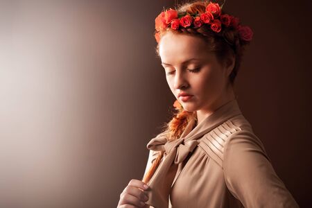 Beautiful serene woman on brown background.の写真素材