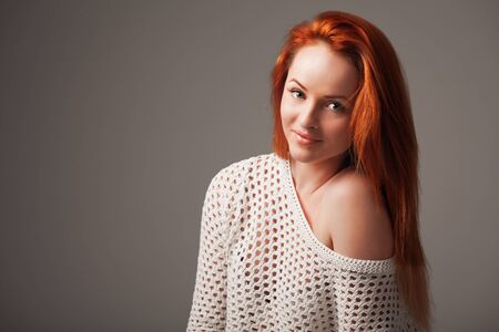 Gorgeous ginger woman on lilac background.