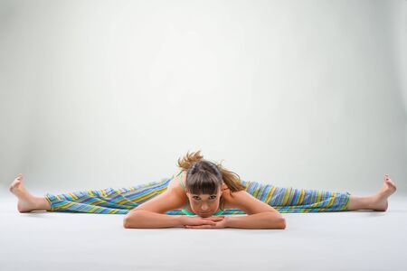 Beautiful young woman doing split.の写真素材
