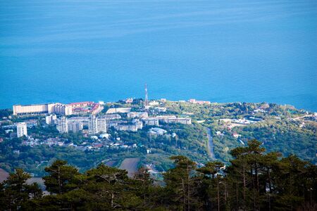 Aerial view mesmerizing view of the city of hills and forests near the coastal village and the blue...