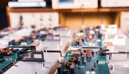 Microcircuits and components lie on metal plates during the production of super modern military...