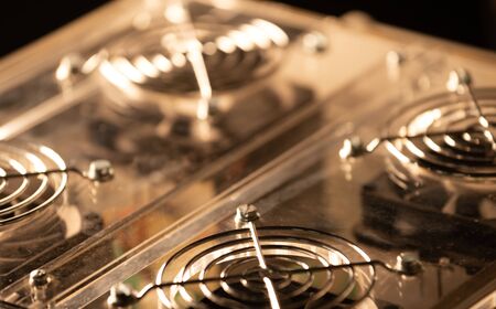 Close-up of four round lattices on a transparent acrylic case of a powerful computer. Supercomputer...