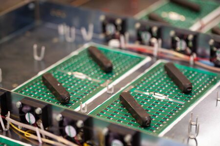 Metal components and microcircuits lie on metal compartments during the production of cases of future powerful supercomputers with video fruits. Concept production of specialized mining computersの写真素材