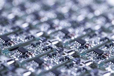 Close-up small microcircuits lie next to each other in the production of audio parts for a speaker...