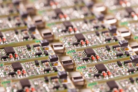 Close-up small microcircuits lie next to each other in the production of audio parts for a speaker...