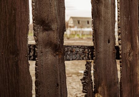 Burnt fence boards after a fire in a private house.の写真素材