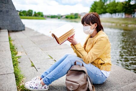 Middle-aged woman in casual clothes and medical maskの写真素材