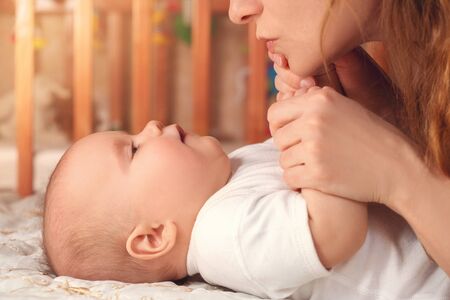 Happy mom plays with her young son. Harmony and love between mother and son