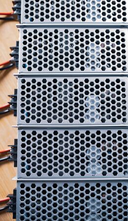 Top view of the metal mesh power supply of the microcircuit are on a wooden table at the production...