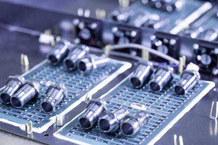 Metal components and microcircuits lie on metal compartments during the production of cases of future powerful supercomputers with video fruits. Concept production of specialized mining computersの写真素材