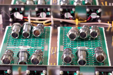 Metal components and microcircuits lie on metal compartments during the production of cases of future powerful supercomputers with video fruits. Concept production of specialized mining computersの写真素材
