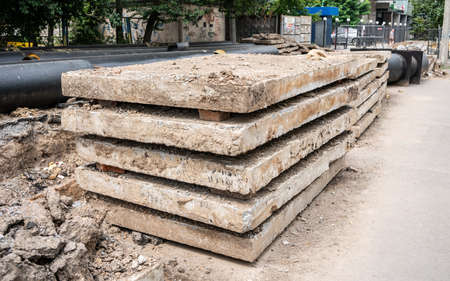Insulated huge pipes and concrete slabs on city road.の写真素材