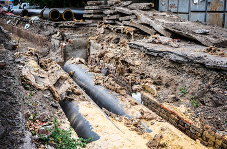 Insulated huge pipes and concrete slabs on city road.