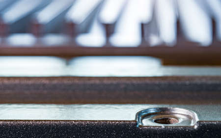 Close-up of a fluted metal surface with bolt hole on an unidentified automatic control device in a...