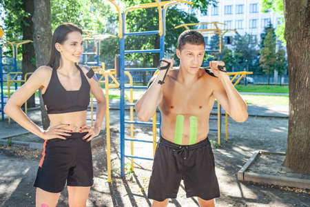 Instructor training man at sports ground.