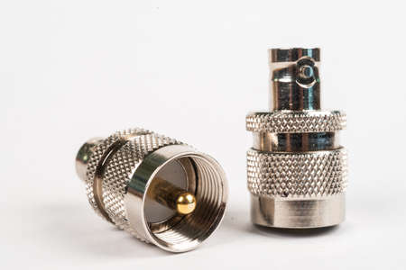 Microwave coaxial adapter 7 16 DIN Male To N Female connector. Concept of radio details. High frequency component with a metallic covering on white backgroundの写真素材