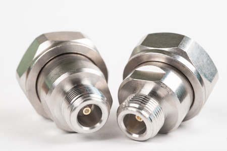 Microwave coaxial adapter 7 16 DIN Male To N Female connector. Concept of radio details. High...