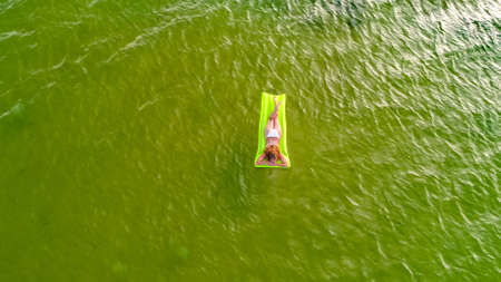 Woman swims in the sea on the motras