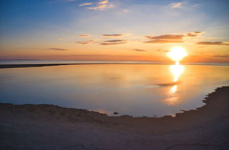 Unusual islands on a brilliant lake and colorful sunsetの写真素材