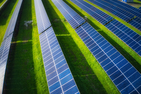Huge solar power plant to use solar energy in a picturesque green field in Ukraine. Aerial panoramic drone shotの写真素材