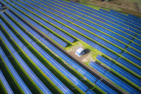 Huge solar power plant to use solar energy in a picturesque green field in Ukraine. Aerial panoramic...