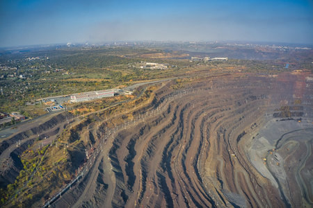 Extraction of minerals with the help of special equipment in the warm evening light in picturesque Ukraine. Aerial panoramic drone shotの写真素材