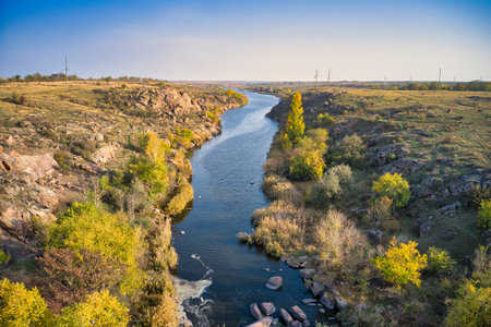 A small fast stream Kamenka in the wilderness in the evening light in Ukraine. Aerial panoramic...