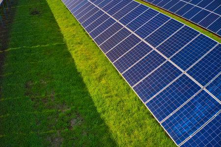 Huge solar power plant to use solar energy in a picturesque green field in Ukraine. Aerial panoramic...