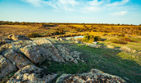 Huge deposits of stone minerals in a clearing bathed in warm sun in picturesque Ukraineの写真素材