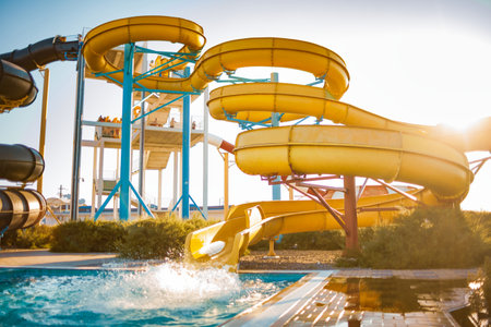 An woman descended from a slide into a pool with transparent water