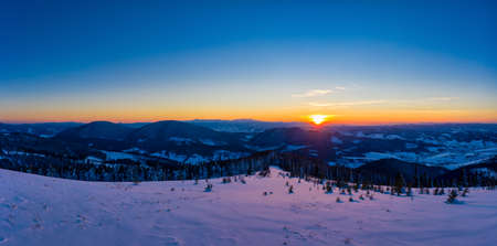 Picturesque winter panorama of snowy mountain hillsの写真素材