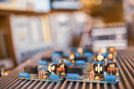 Microcircuits and components lie on metal plates during the production of super modern military...