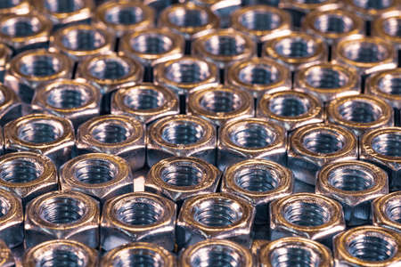 Close-up chrome metal nuts in the form of honeycombs
