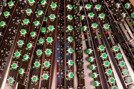 Close-up of a LED panel of green light indicators is in the production. The concept of industrial...