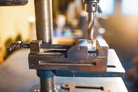 Drilling machine at the workplace in workshopの写真素材