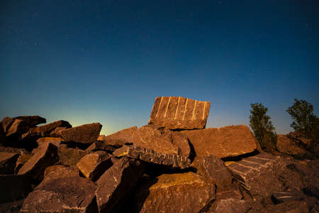 Stone materials near old flooded stone quarry