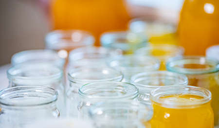 Composition of a large number of transparent empty glass jars and three large glass transparent jars...