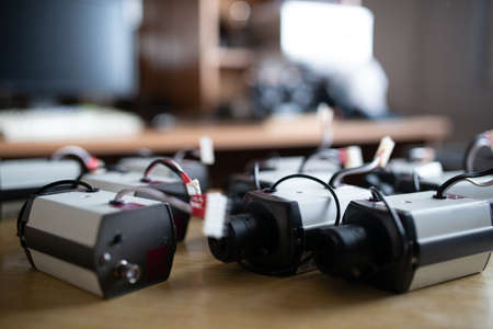Electronic devices plastic casings with cables and USB connectors for TFT monitors on table in...