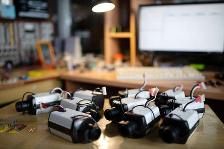 Electronic devices plastic casings with cables and USB connectors for TFT monitors on table in...