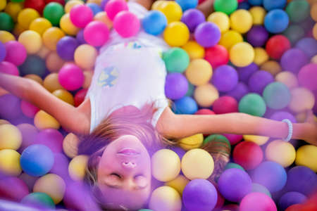 Girl in a T-shirt spends time in the playroom enjoying a summer dayの写真素材
