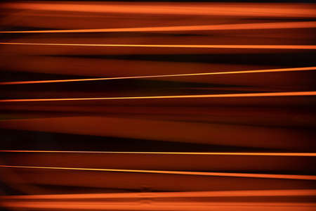 Bright dark red-orange background in fiery and fiery stripes with an abstract patternの写真素材
