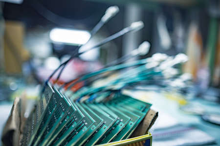 Set of chips on microcircuit board for contemporary TFT displays in cardboard box in plant assembling workshop extreme closeupの写真素材