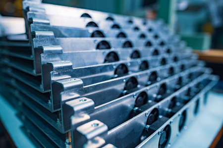 Cold shiny metal parts with thin cables for modern TFT displays on a large table in the assembly shop factory macro viewの写真素材