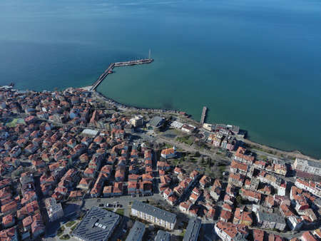 A birds eye view of the small, densely populated old town of Pomorie, which sits on a peninsula of beautiful rocky Bulgaria and is lapped by the big blue, salty Black Seaの写真素材